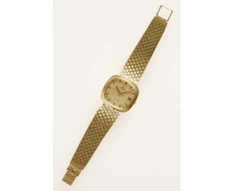 OMEGA: A GENTLEMAN'S YELLOW GOLD WRISTWATCH, the gilt dial with raised baton numerals, sweep second hand and date aperture, i