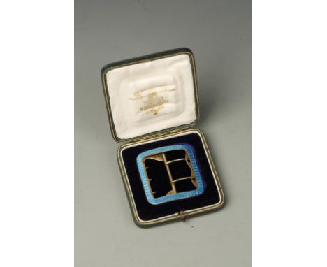 A YELLOW METAL AND BLUE ENAMEL BUCKLE, stamped Child and Child London S.W., in original fitted case