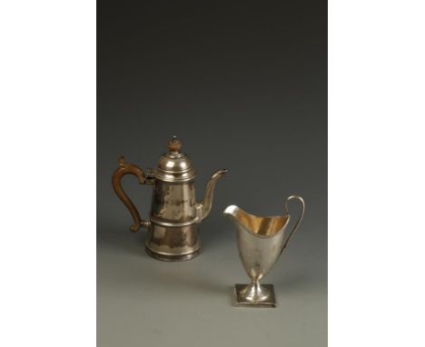 A GEORGE III CREAM JUG of helmet form with a beaded border and reeded handle, on a square base, initialled, makers mark rubbe