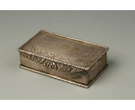 A WILLIAM IV TABLE SNUFF BOX of rectangular form with a raised foliate border, the cover with chased foliate decoration with 