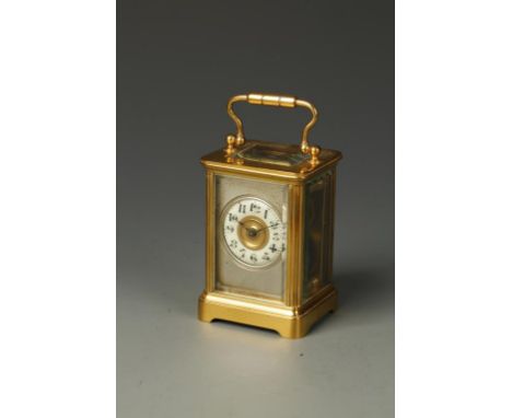 A FRENCH BRASS CASED MINIATURE CARRIAGE CLOCK, the cream enamel chapter ring with Arabic numerals, surrounded by a silvered m