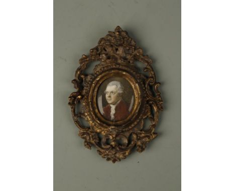 A PORTRAIT MINIATURE, head and shoulders of a gentleman in a red jacket, looking to his left, oval, 1.5" x 1.25", 18th centur