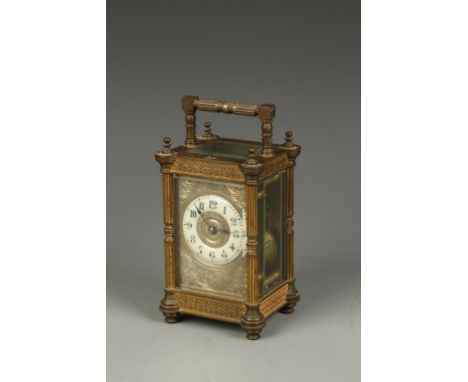 A FRENCH BRASS CASED STRIKING CARRIAGE CLOCK, the cream chapter ring with Arabic numerals, engraved gilt centre and surroundi