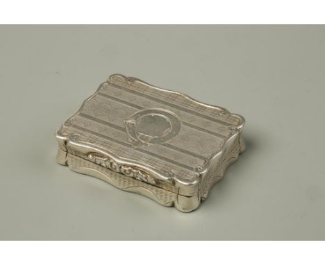 A VICTORIAN VINAIGRETTE of shaped rectangular form with engine-turned decoration, circular cartouche and gilt interior, the g