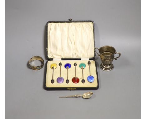   A cased set of six silver and enamel(a.f.) bean end coffee spoons, one other silver spoon, a silver napkin ring and small s