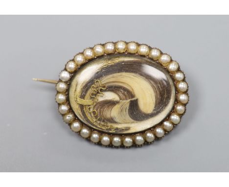   A Victorian yellow metal and split pearl set oval locket, with lock of plaited hair below a glazed panel, 27mm, gross 6.6 g