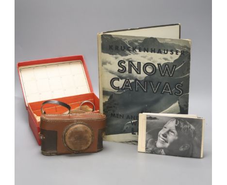   A Leica standard camera, number 145405 (1934), with leather case and a book