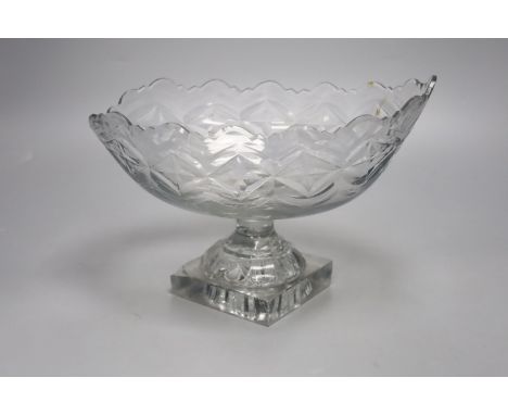   A George III Irish oval cut glass fruit bowl, lemon squeezer base, 27cm long (a.f)