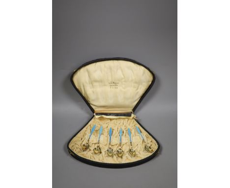   A cased set of six Norwegian gilt white metal and enamel coffee spoons (enamel a.f.).
