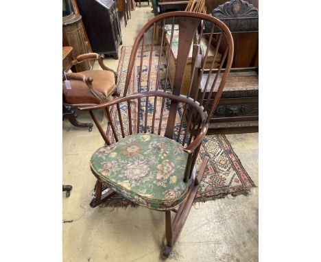   An Ercol comb back stained beech rocking chair, width 60cm, depth 50cm, height 106cm