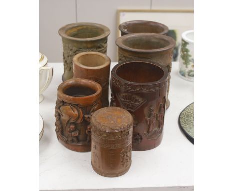   Six 19th/20th century Chinese carved brush pots and a similar carved tea caddy, tallest 20cm