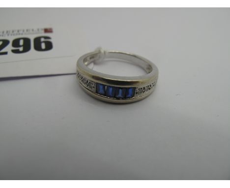 A Modern Diamond Set Ring, of graduated design, rubover set to the centre, stamped "14k" (finger size O) (3grams). 