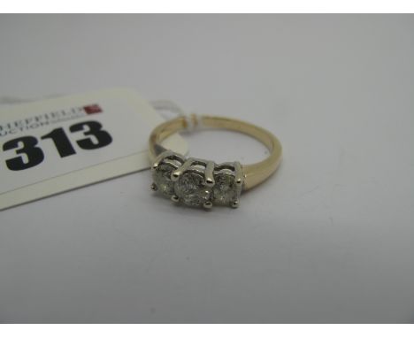 A Modern Three Stone Diamond Ring, the brilliant cut stones claw set, stamped "14k" (finger size O). 