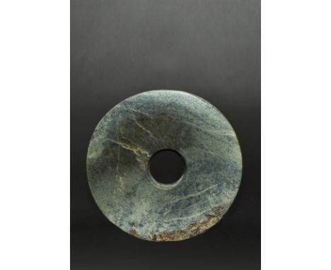 Exceptional large neolithic bi disc. It has a subtle range of colours including blue, green, grey, black and creamy white. Th