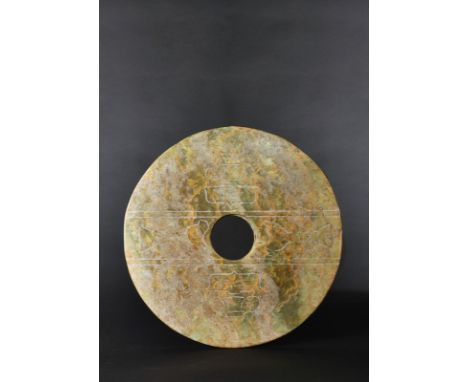 Liangzhu period (3400 – 2250 BC) This jade bi disc is of exceptional size and decoration. The inner and outer edges are smoot