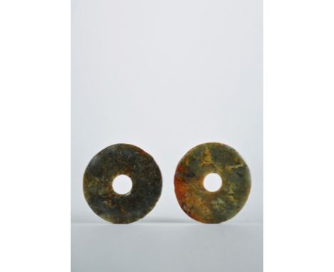 Neolithic period
 
A pair of neolithic jade bi discs, with red and green colours and surfaces showing a cloud-like pattern. T