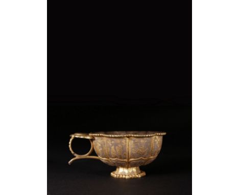 Tang dynasty (618 – 907AD) A silver gilt lobed Tang cup supported by eight lotus petals opening out from the base. The lobes 