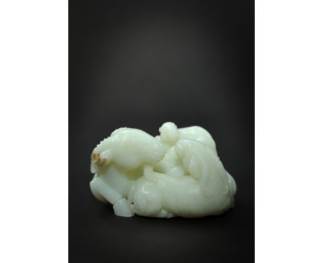 An 18th century white jade group of 3 rams, the jade of pure mutton fat colour carved almost in the round to show a ram, head