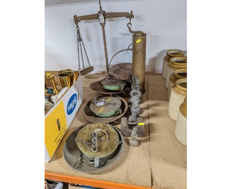 Four vintage sets of scales, brass shell casing and five weights 