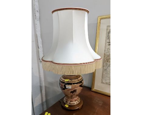 Floral gilt table lamp with tasselled shade  