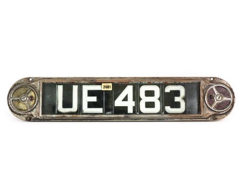 A MID 20TH CENTURY METAL FRAMED AUTOMOBILE NUMBER PLATE AND SURROUND71cm long; 15cm high