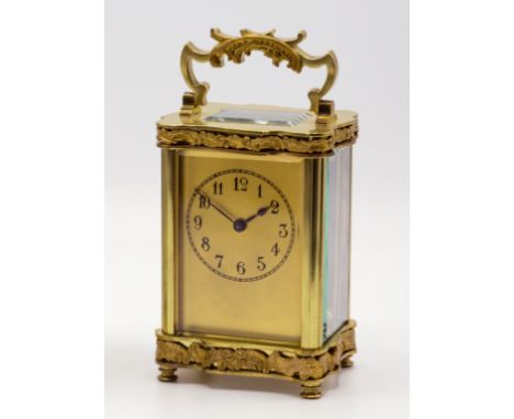 A gilt brass Louis XV Doucine cased carriage clock, c.1900, the gilded face with painted Arabic dial, the serpentine case wit