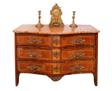 An early 19th century French serpentine fronted commode, of two short over two long drawers, the Alba Rosa marble top over an