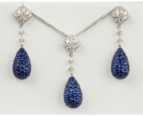 An 18ct white gold, sapphire and diamond cluster pendant with matching earrings en suite, the pendant and earrings each of te