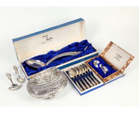 A Thai sterling silver serving spoon, 1950s, the diamond shaped handle with repoussé decoration of a deity and scrollwork, tu