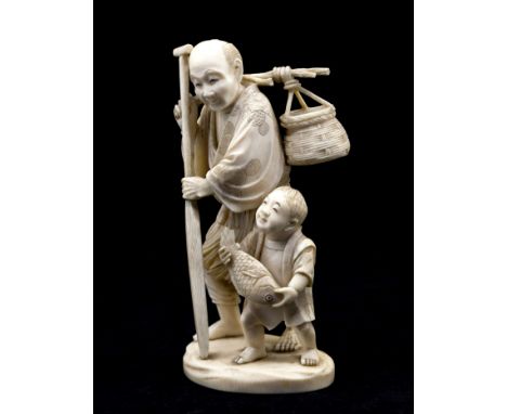 A Japanese carved ivory okimono of a fisherman and boy, Meiji period (1868-1912), the man standing holidng an oar, a basket o