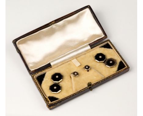 A cased set of Art Deco 9ct gold, platinum and black onyx cufflinks and studs, the octagonal black onyx faces centred with a 