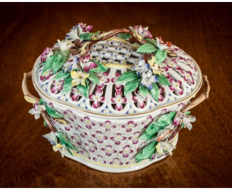 A rare Worcester ceramic chestnut basket, third quarter 18th century, of oval quatrefoil lobed form, reticulated cover with i