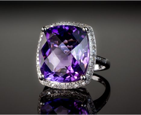 A 14ct white gold, amethyst and diamond cluster ring, the approx. 13.65ct cushion cut amethyst within a halo border of eight 