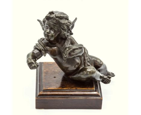 An Italian School 19th century bronze figure of a seated cherub/Putto, holding a dove in his left hand, well detailed with fl