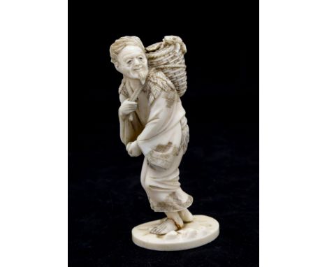 A Japanese carved ivory okimono of Gama Sennin, Meiji period (1868-1912), well carved, walking with his head inclined left an