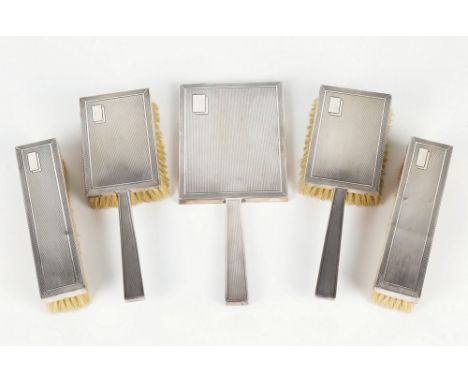 A George VI Art Deco style silver five piece dressing set, D. P. Martin, Birmingham 1948, comprising a hand mirror, pair of h