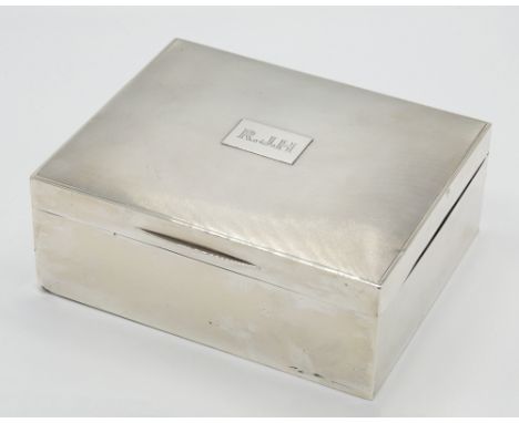 A George V silver cigar box, Padgett & Braham Ltd., London 1929, rectangular with engine turned lid, the central plaque initi