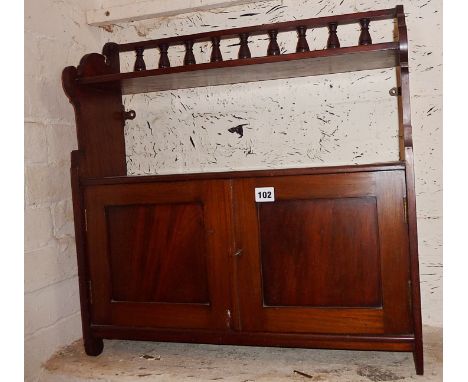 Late Victorian mahogany wall shelf with two cupboards, doors and turned gallery