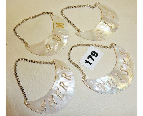 Four Mother of Pearl decanter labels with pierced legends, Sherry, Rum, Whisky and Gin