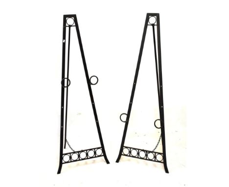 Pair of wrought iron easel stands, 133cm high  