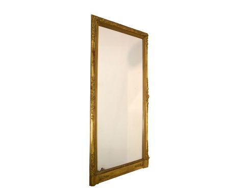 19th Century gilt-framed pier or console mirror, with plain rectangular plate in cushion-moulded frame with floral decoration