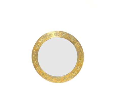 Arts and Crafts style circular curved mirror having brass repoussé border decorated with celtic knot motifs. Diameter 45cm.Co