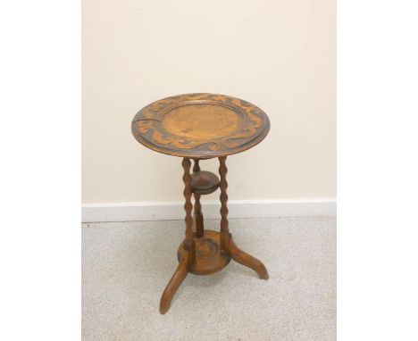 Oak Arts and Crafts rotating top wine table or jardinière stand, c.1900, the circular recessed top with carved scrolling bord