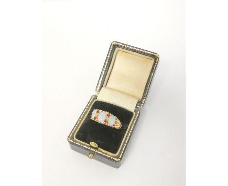 9ct gold opal and garnet three stone ring. Size P 3.6g.