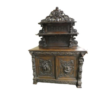 19th century Gothic revival oak buffet sideboard profusely carved having twin panel doors opening to reveal shelved interior,