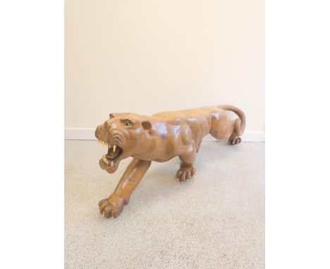 Antique Japanese Meiji period carved rosewood sculpture of a tiger having painted eyes and ivory teeth and claws. Length 117c