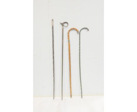 Four Antique canes to include a blackthorn swagger stick with silver mount dated to 1900, a silver mounted bamboo walking sti