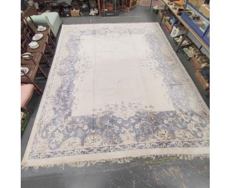 Chinese style muted silk and wool carpet with central white floral panel encircled by a blue and brown floral border. 400cm x