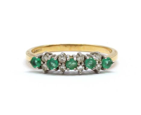 An 18ct gold emerald and diamond ring, with alternating round mixed cut emeralds and pairs of eight cut diamonds, claw set, t