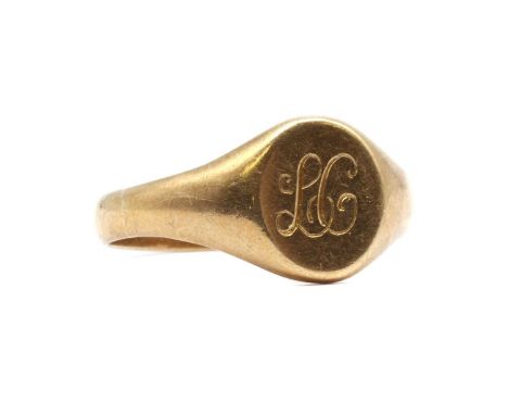 A 9ct gold signet ring, the oval head with engraved initials, to tapered shoulders and a 'D' section shank, Birmingham, 3.47g